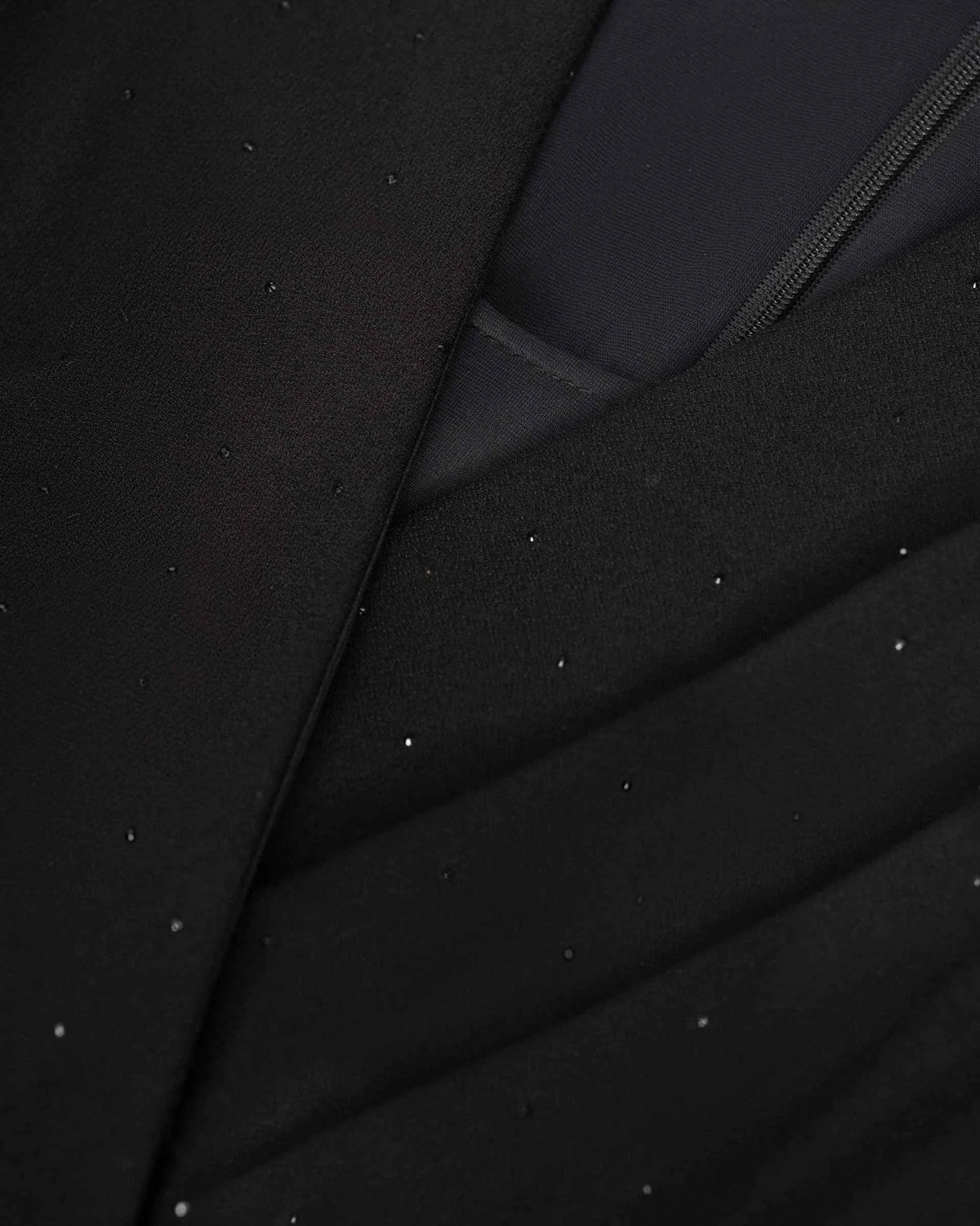 The front layers cross diagonally through the bodice, creating a softly wrapped appearance.