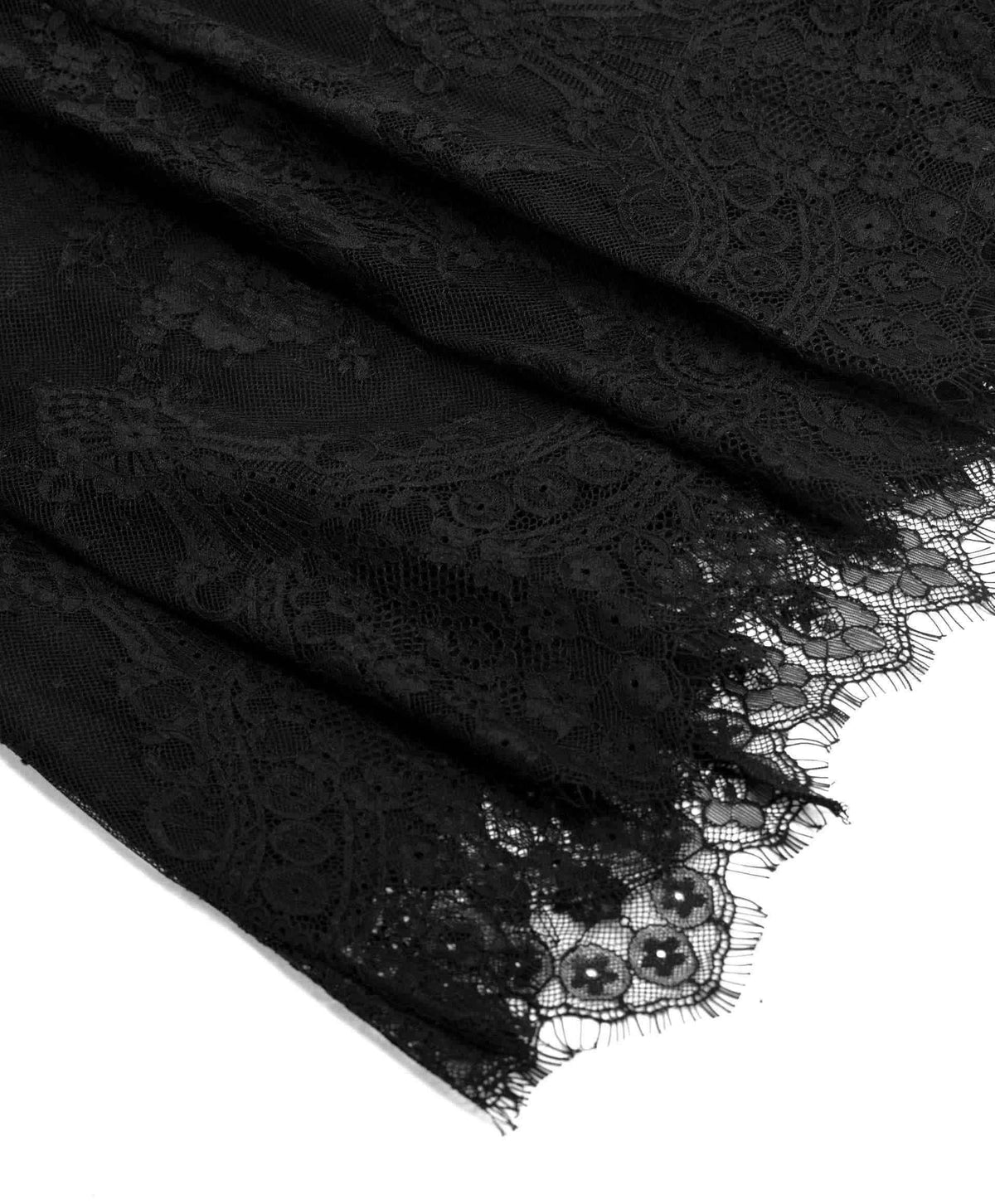 The lace gathers into soft folds before finishing in a fine scalloped border.
