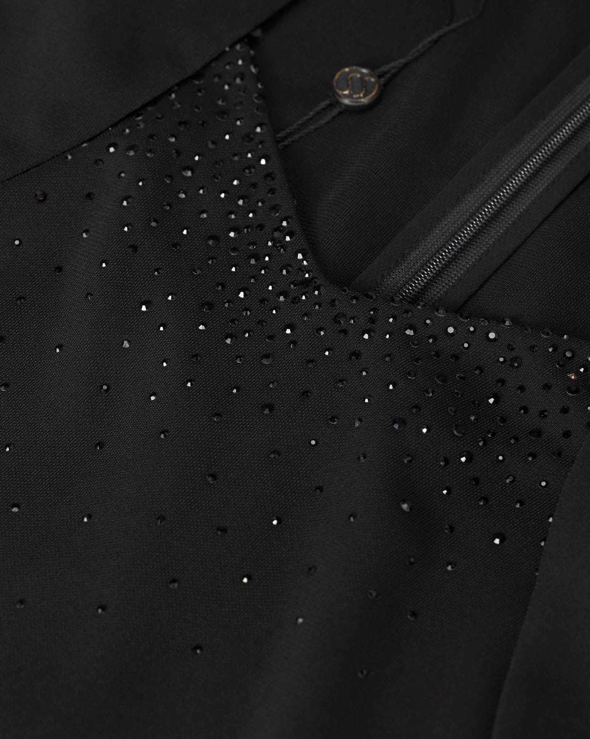 Small dark decorative accents follow the neckline beside a narrow opening.