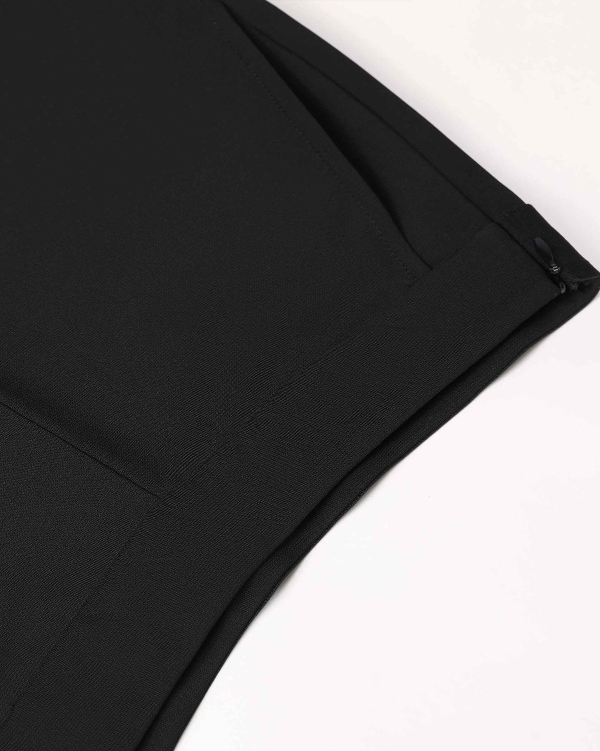 The close view reveals the waistband, fastening and nearby seam lines in black.
