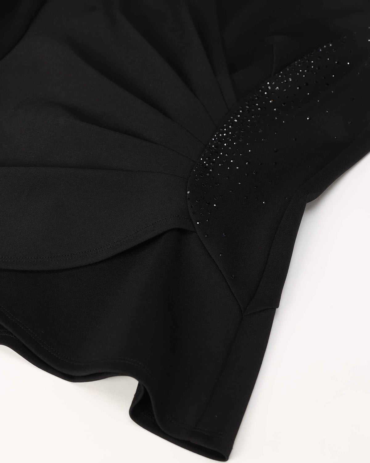 A curved line of dark decorative accents sits beside the gathered waist.