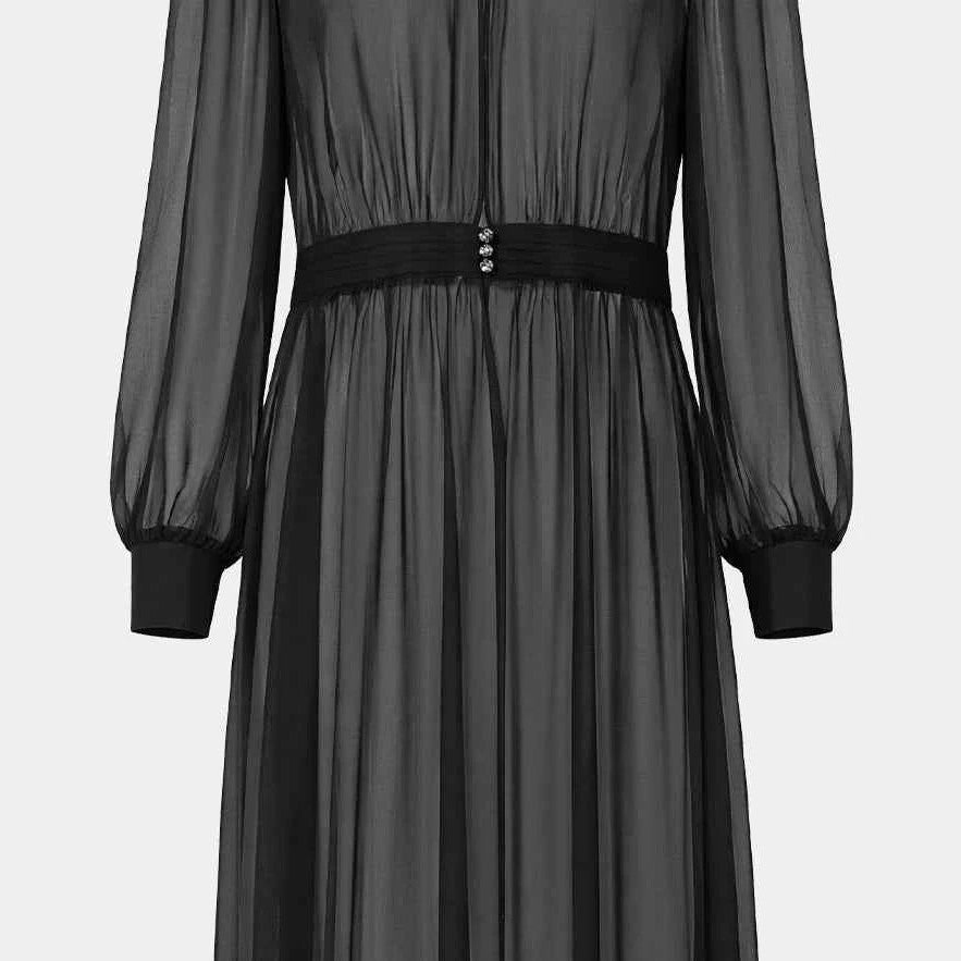 The long transparent outer layer gathers at the waist above a softly falling skirt.